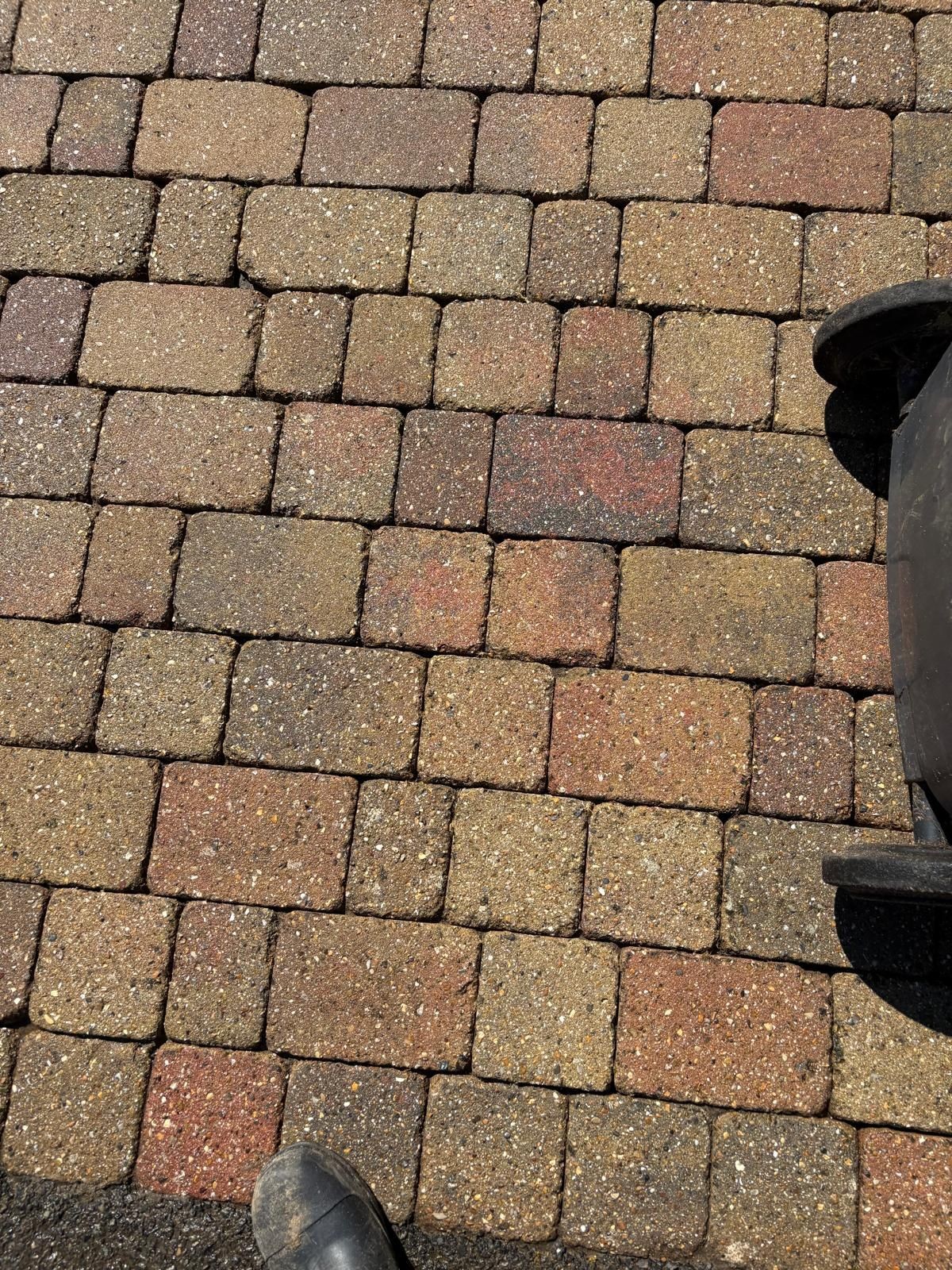 Close-up of a textured cobblestone path with a hint of a boot in the corner.